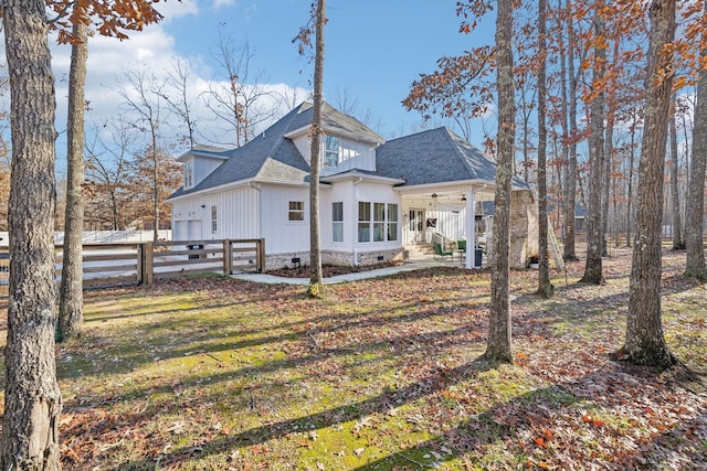 back of house with a yard and ceiling fan