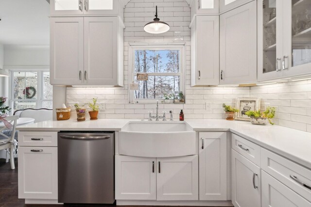 kitchen with white cabinetry, stainless steel dishwasher, and plenty of natural light