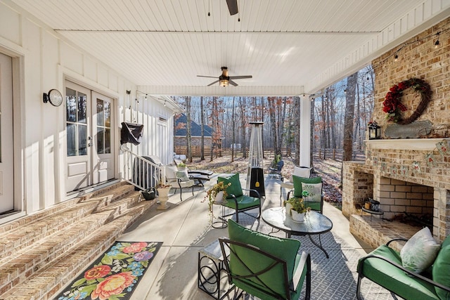 view of patio / terrace with ceiling fan and an outdoor brick fireplace