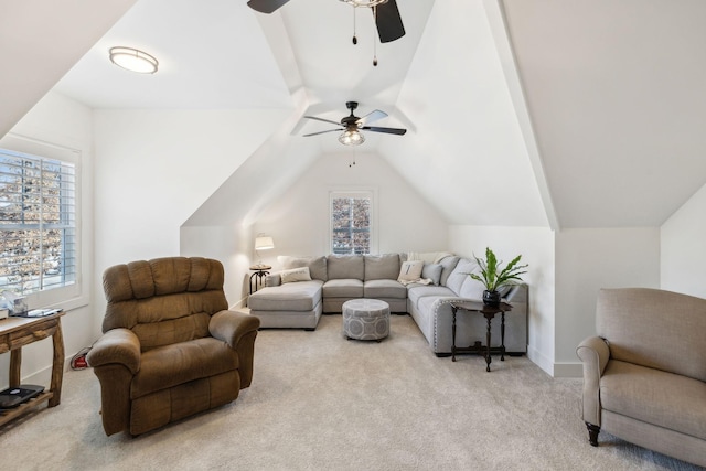 carpeted living room with ceiling fan and lofted ceiling