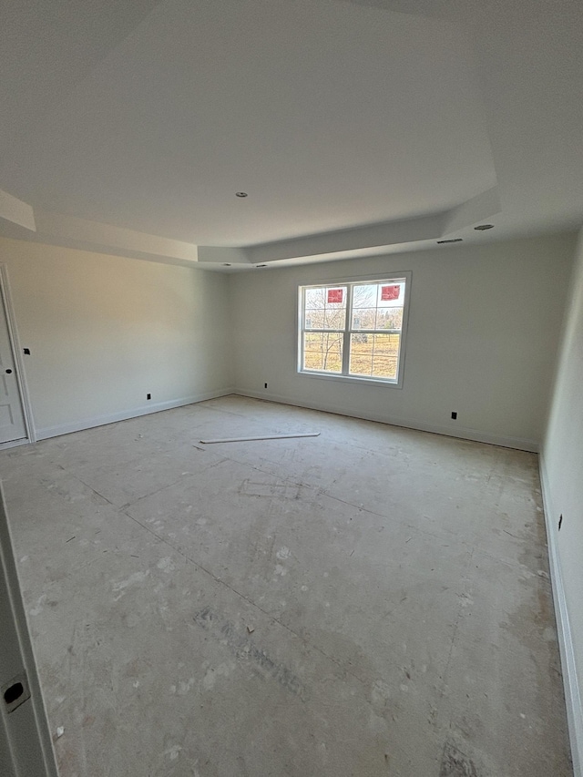 spare room featuring a raised ceiling