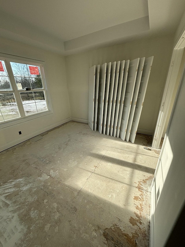 empty room featuring a tray ceiling