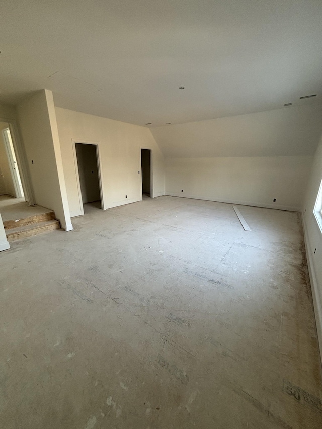 empty room featuring vaulted ceiling