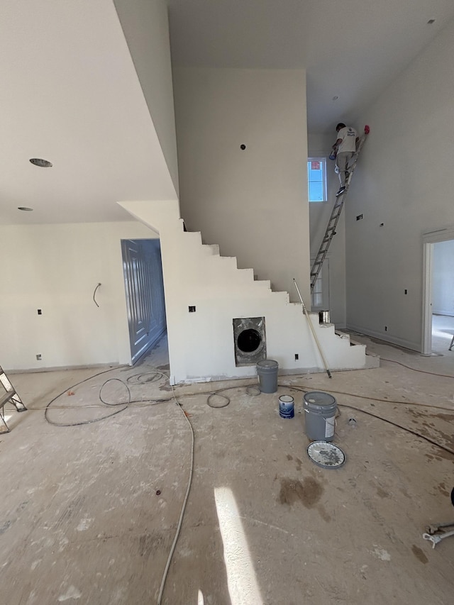 interior space featuring a towering ceiling and a fireplace