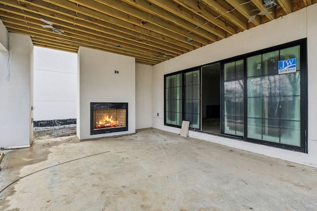 view of patio with a fireplace