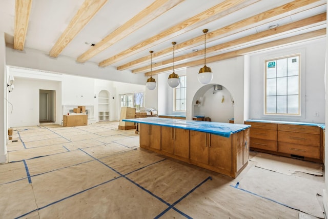 miscellaneous room featuring built in shelves and beamed ceiling