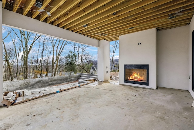 snow covered patio with exterior fireplace