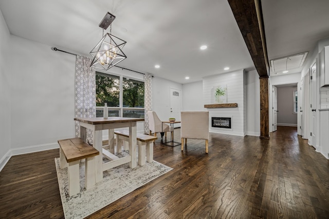 dining room featuring beam ceiling, a fireplace, dark hardwood / wood-style floors, and a notable chandelier