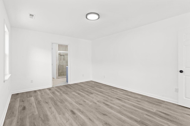 spare room featuring light wood-type flooring