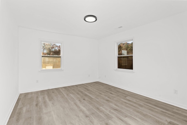 unfurnished room featuring light hardwood / wood-style floors