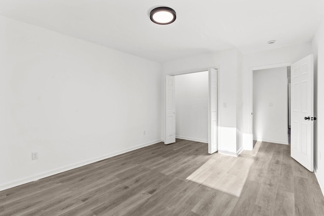 unfurnished bedroom with hardwood / wood-style flooring