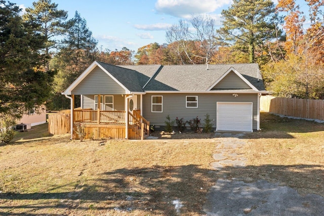 single story home with covered porch, central AC, and a garage