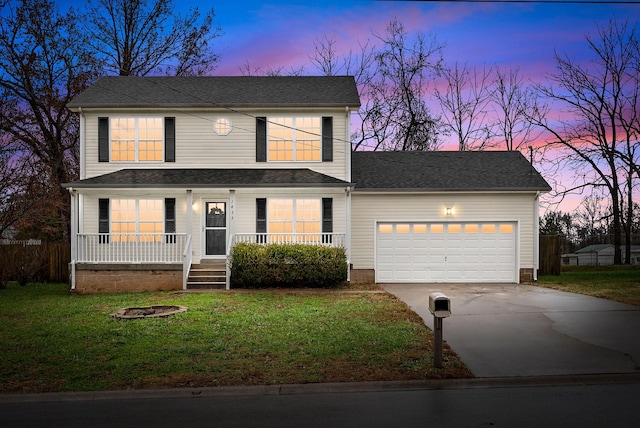 front facade featuring a lawn, a porch, and a garage