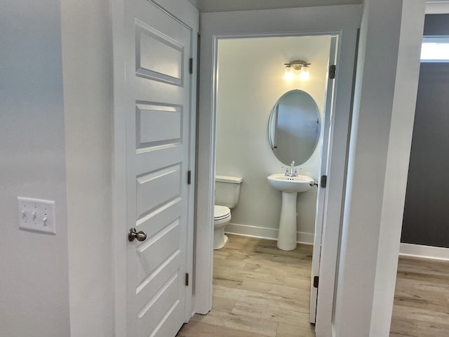 bathroom featuring hardwood / wood-style floors, sink, and toilet