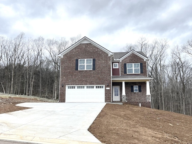 view of front of home with brick siding, an attached garage, and concrete driveway