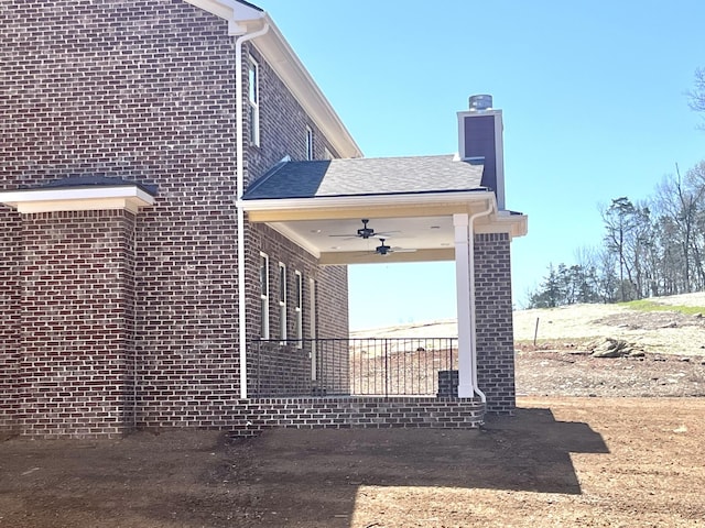 610 Spring Hill Dr, Smyrna, TN 37167 - view of side of home featuring a ceiling fan, brick siding, and a chimney