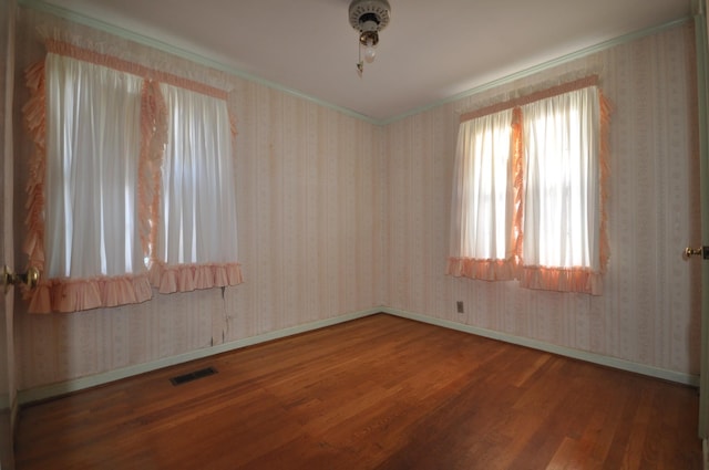 unfurnished room with hardwood / wood-style floors