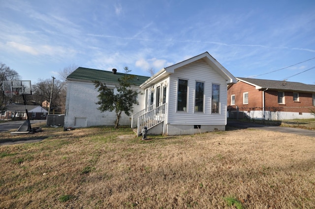 view of home's exterior with a yard