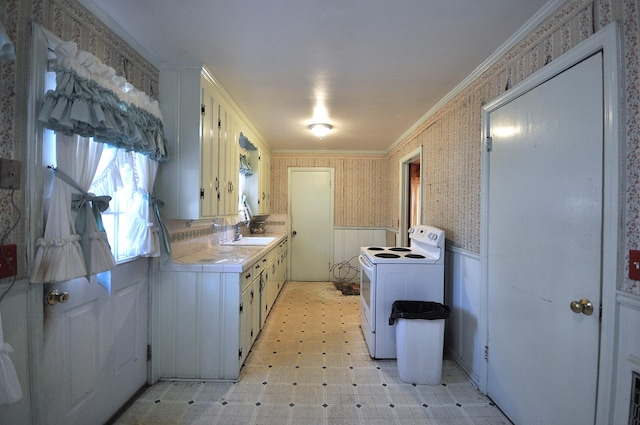 kitchen featuring sink, tile counters, washer / clothes dryer, electric stove, and ornamental molding