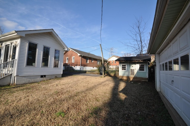 view of property exterior with a yard and an outdoor structure