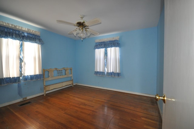 interior space with dark hardwood / wood-style floors and ceiling fan