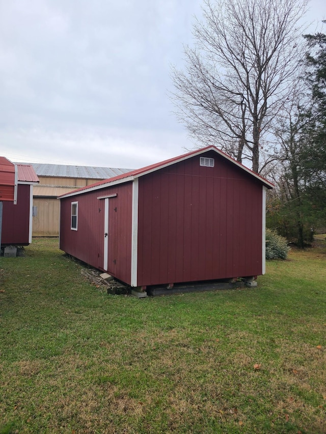 view of outdoor structure featuring a lawn