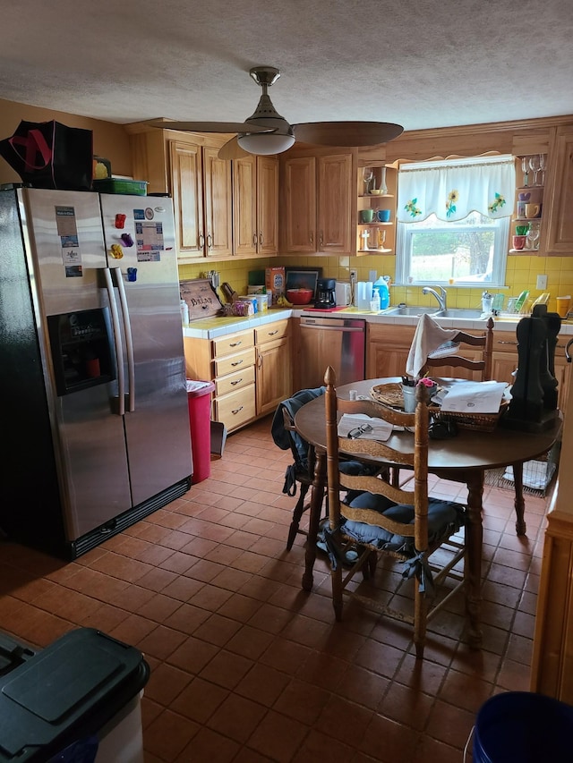 kitchen featuring light tile patterned floors, stainless steel appliances, and tasteful backsplash