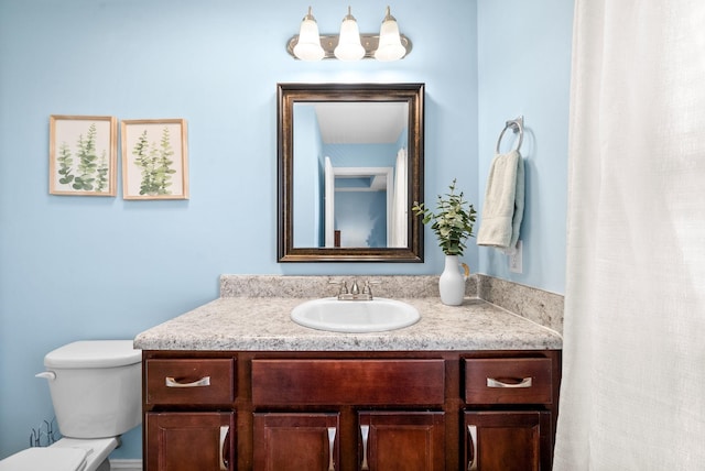 bathroom featuring toilet and vanity