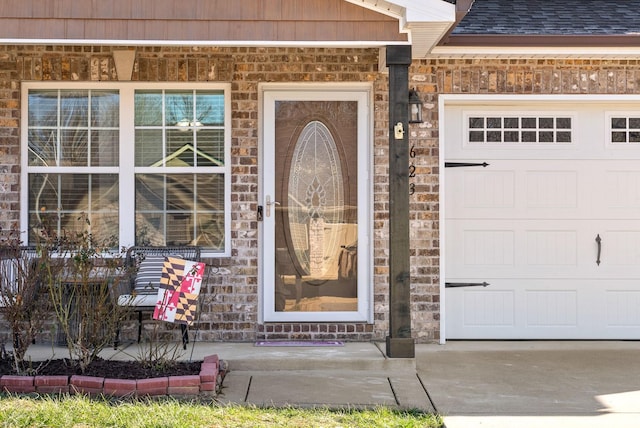 view of exterior entry featuring a garage