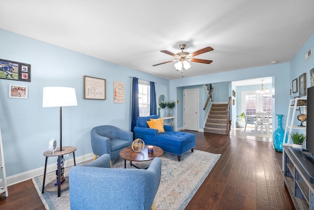 living room with ceiling fan and dark hardwood / wood-style floors