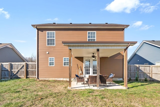 rear view of house featuring a patio, ceiling fan, a lawn, and outdoor lounge area