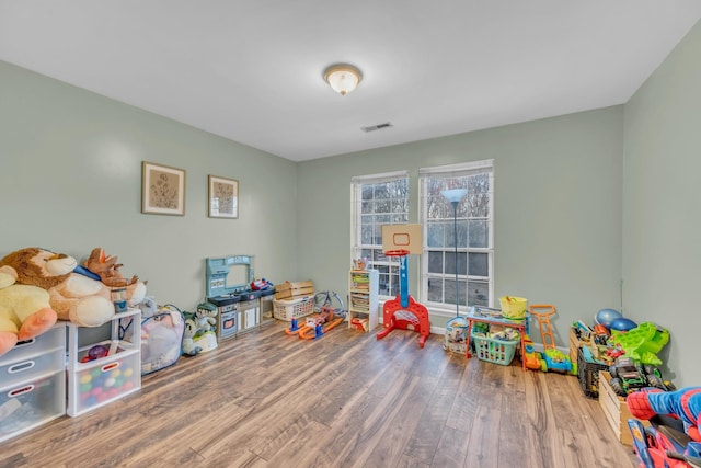 playroom featuring wood finished floors and visible vents