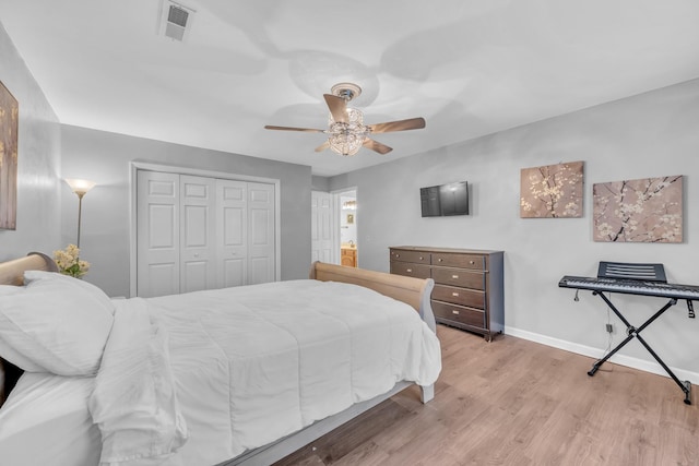 bedroom featuring light hardwood / wood-style flooring, a closet, and ceiling fan