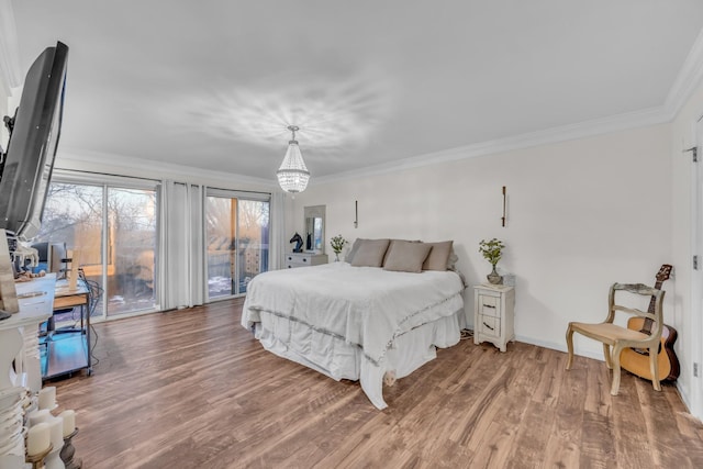 bedroom with wood-type flooring, access to outside, an inviting chandelier, and ornamental molding