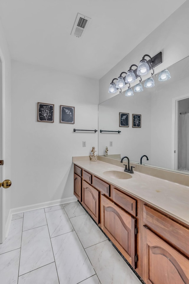 full bath featuring marble finish floor, visible vents, vanity, and baseboards