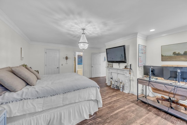 bedroom featuring a notable chandelier, wood-type flooring, and crown molding