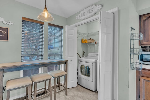 laundry room featuring washer / dryer and laundry area