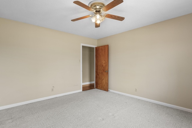 unfurnished room with ceiling fan and light colored carpet