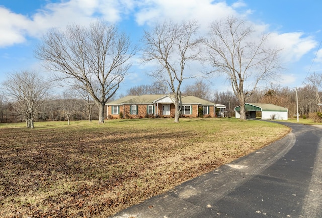 single story home with a front lawn and a carport