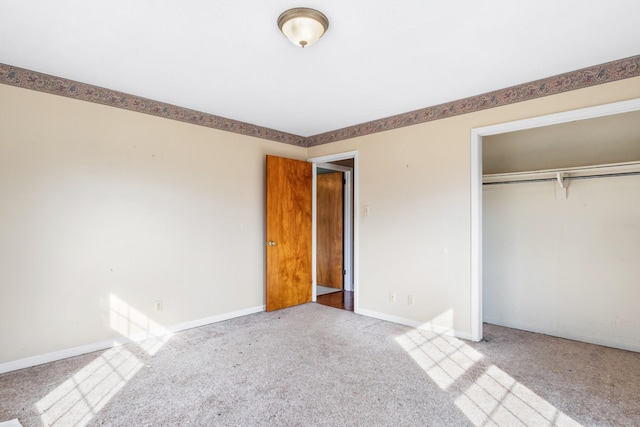 unfurnished bedroom with light carpet and a closet