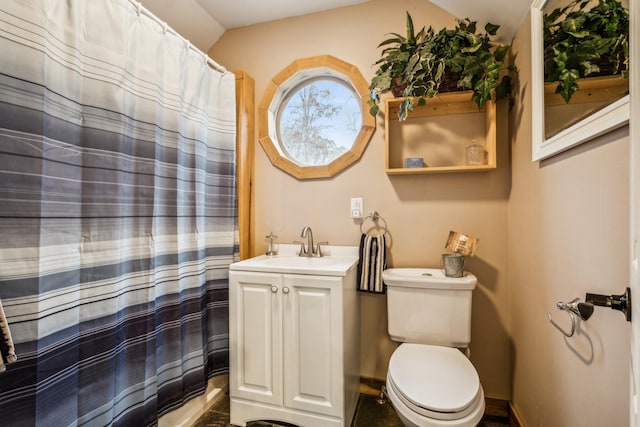 bathroom featuring vanity, toilet, and curtained shower