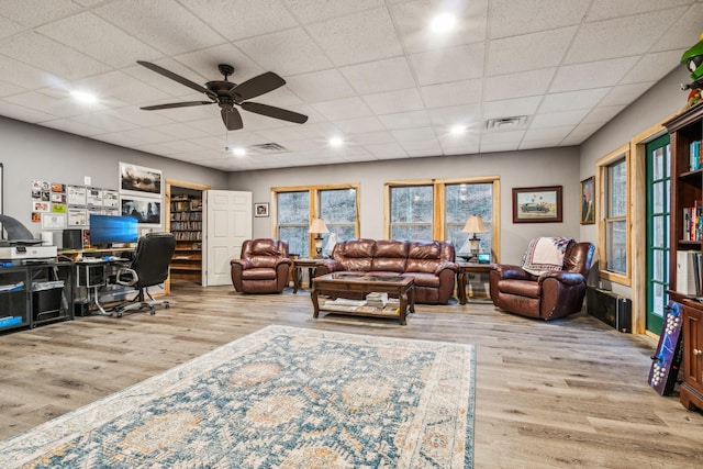 office space featuring a paneled ceiling, light hardwood / wood-style floors, and ceiling fan