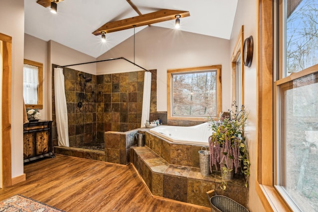 bathroom featuring independent shower and bath, hardwood / wood-style floors, and vaulted ceiling with beams