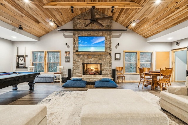 playroom featuring a stone fireplace, a healthy amount of sunlight, high vaulted ceiling, and wood ceiling