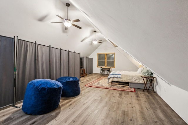 bedroom with hardwood / wood-style flooring, ceiling fan, and vaulted ceiling with beams