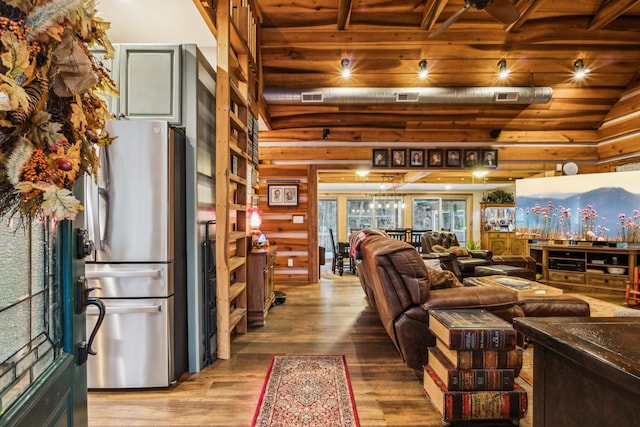 living room featuring hardwood / wood-style floors, vaulted ceiling, and wooden ceiling