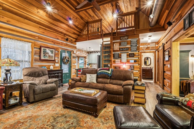 living room featuring ceiling fan, wooden ceiling, high vaulted ceiling, wood walls, and wood-type flooring