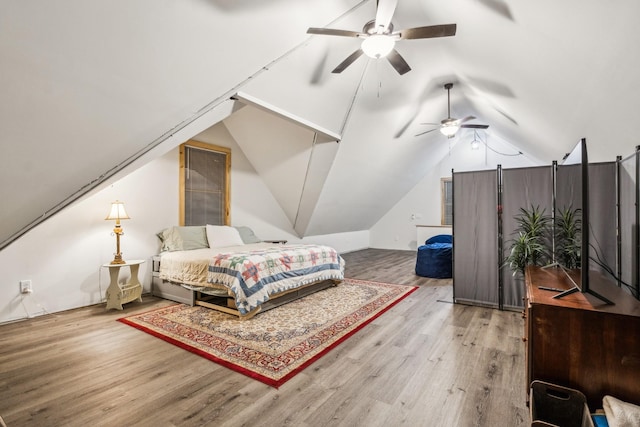 bedroom featuring lofted ceiling, hardwood / wood-style floors, and ceiling fan