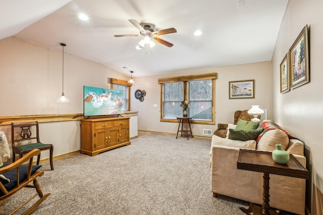 carpeted living room with vaulted ceiling and ceiling fan