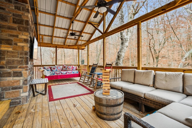 sunroom / solarium featuring lofted ceiling and ceiling fan